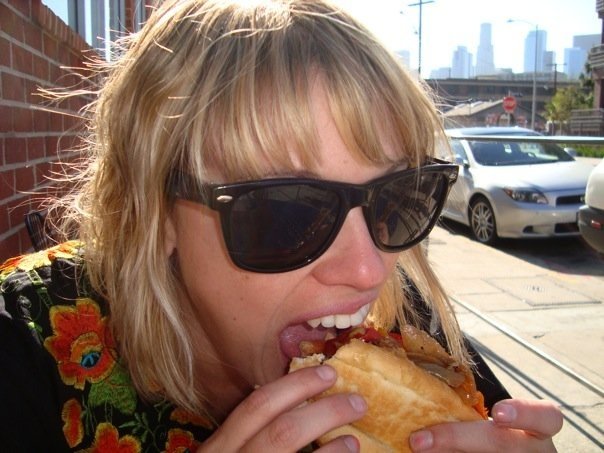 I see Downtown LA behind her. Not far from me. I wonder where she got herself a kielbasa?